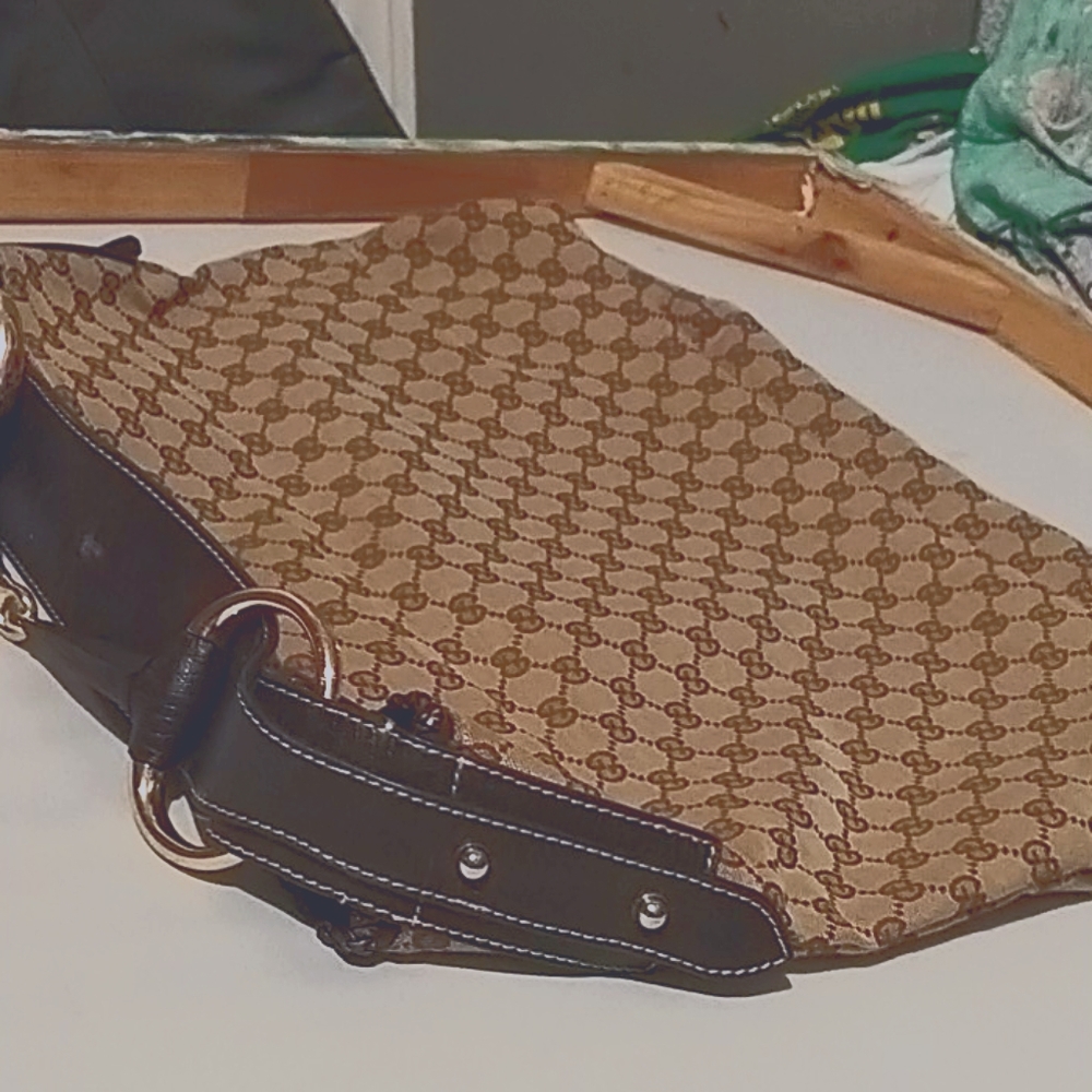 Gucci tote with 2 peices of paperwork.